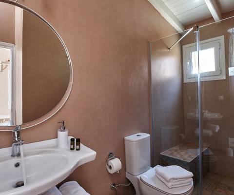 Marni Hotel Two Bedroom Apartment bathroom with walk-in shower and round mirror