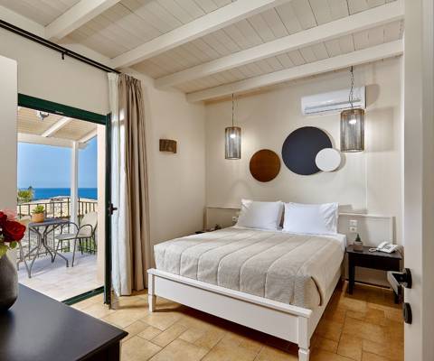 Marni Hotel Villa bedroom with double bed, bedside tables and access to private terrace