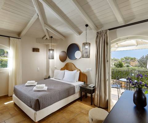 Marni Hotel House Maisonette bedroom with double bed, vaulted ceiling and access to private terrace